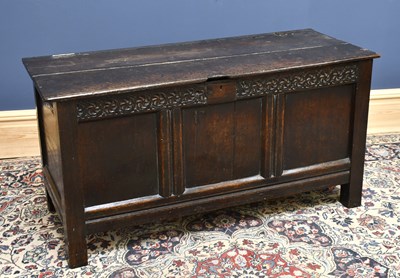 Lot 1663 - An 18th century oak coffer, with carved...