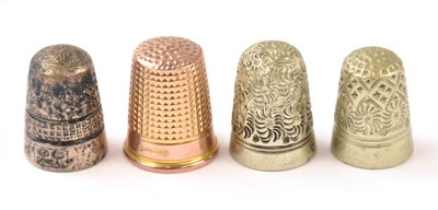 Lot 1035 - A 9ct gold thimble, together with three white...