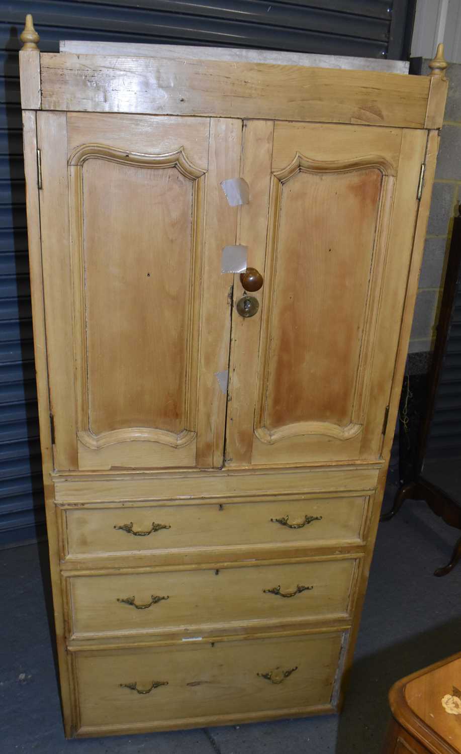 Lot 36 - A Continental pine linen press with three base...