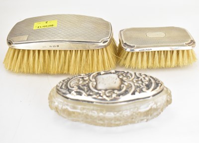 Lot 744 - Two hallmarked silver clad clothes brushes,...