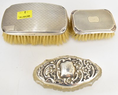 Lot 744 - Two hallmarked silver clad clothes brushes,...