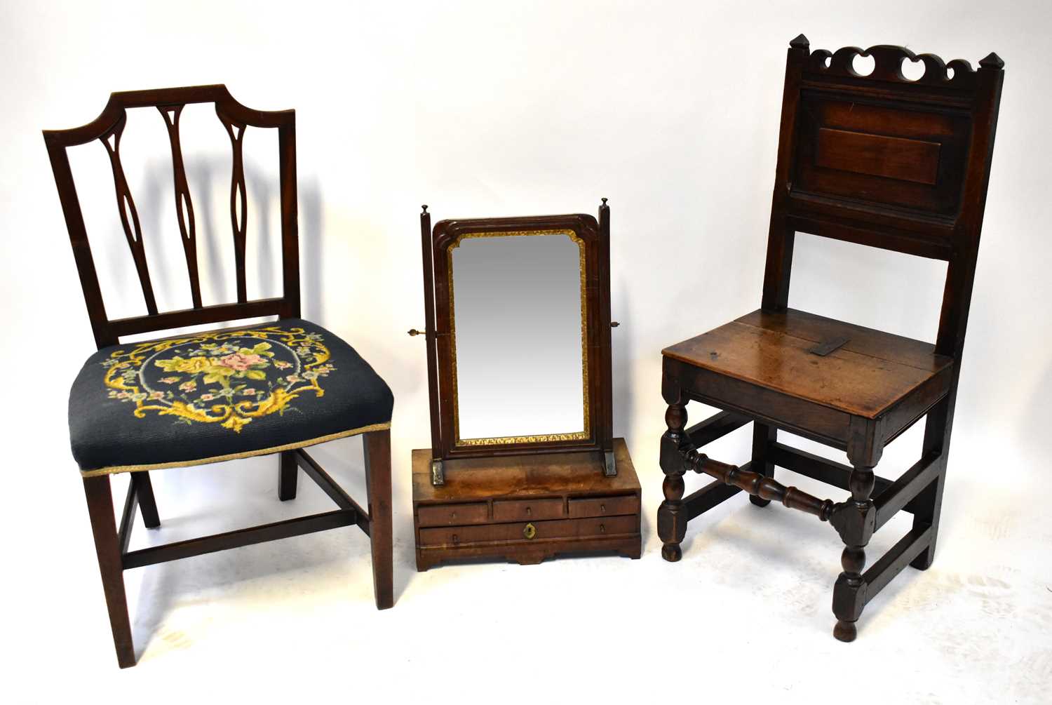 Lot 10 - An 18th century jointed hall chair with carved...