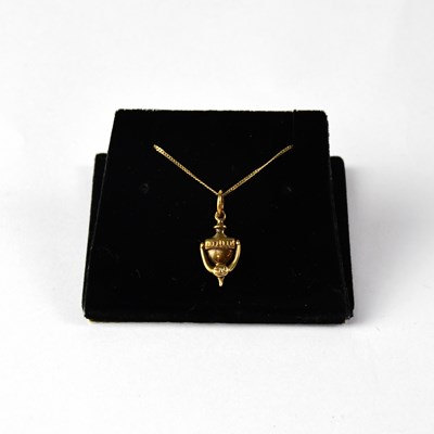 Lot 1104 - A 9ct yellow gold fine link chain with a 9ct...