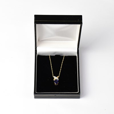 Lot 1165 - A yellow metal link chain with blue and white...