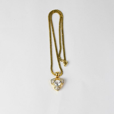 Lot 1084 - An 18ct yellow gold pear-shaped pendant set...