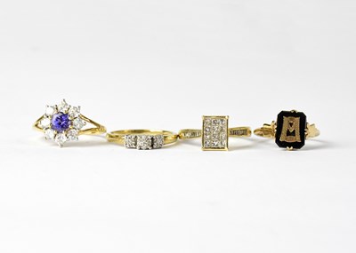 Lot 898 - Four 9ct yellow gold rings comprising a floral...