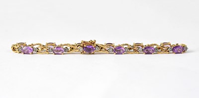 Lot 1024 - A 9ct yellow gold amethyst and diamond chip...
