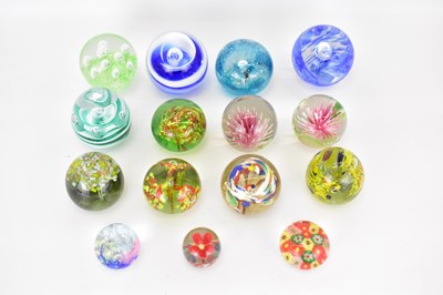 Lot 317 - Fifteen small floral inset glass paperweights...