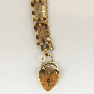 Lot 1045 - A 9ct gold three bar gate bracelet with a 9ct...