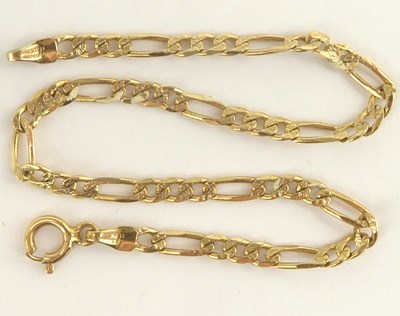 Lot 1017 - A 14ct gold thin figaro link bracelet with...