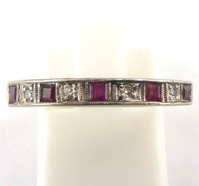 Lot 1006 - An 18ct gold diamond and ruby half eternity...