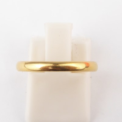 Lot 954 - A 22ct gold thin wedding band, size M, approx....