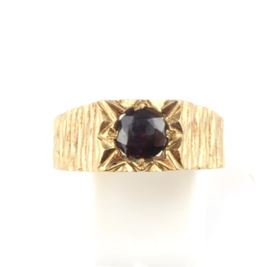 Lot 953 - A 1970s 9ct gold ring with star set cut red...