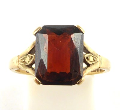Lot 992 - A 9ct gold garnet ring, the claw set square...