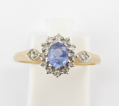 Lot 990 - A 9ct gold dress ring with central blue claw...