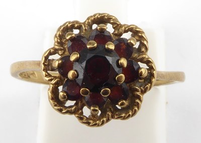 Lot 1013 - A 9ct rose gold ruby ring, the central claw...