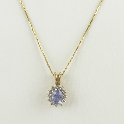 Lot 1120 - A 9ct gold dainty necklace chain with ring...