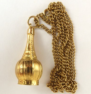 Lot 1109 - A 9ct gold basket clad wine bottle pendant,...