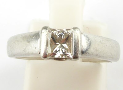 Lot 869 - A platinum solitaire ring, the tension set...