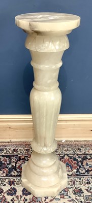 Lot 1522 - A carved alabaster jardinière stand, height 90cm.