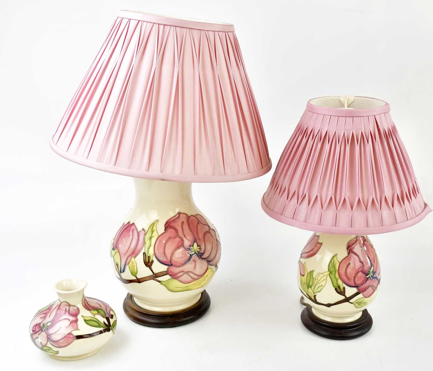 Lot 1414 - MOORCROFT; a graduated pair of lamps and a...