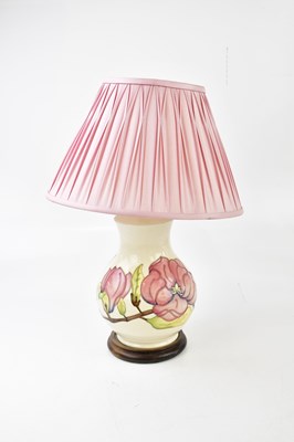 Lot 1414 - MOORCROFT; a graduated pair of lamps and a...