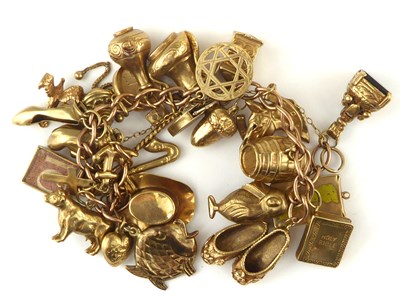 Lot 1050 - A 9ct gold charm bracelet with approximately...