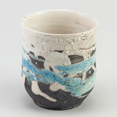 Lot 809 - A raku yunomi partially covered in white and...
