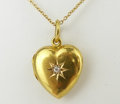 Lot 1085 - A 15ct gold heart-shaped double locket with...