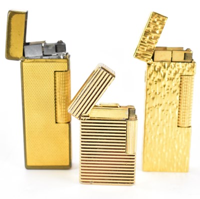 Lot 151 - Three 1970s gold plated lighters to include a...