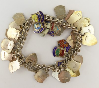 Lot 1056 - A sterling silver charm bracelet set with...
