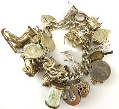 Lot 1055 - A hallmarked silver charm bracelet with...