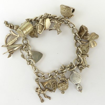 Lot 1054 - A hallmarked silver charm bracelet with...