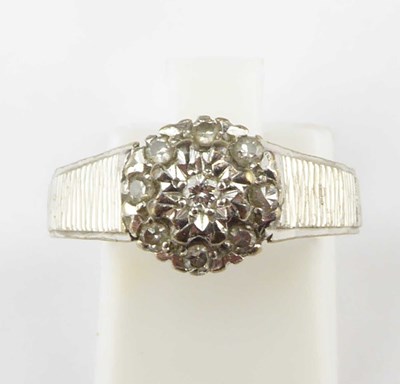 Lot 1001 - A 9ct white gold illusion set diamond cluster...