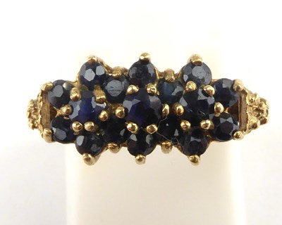Lot 964 - A 9ct gold three-row sapphire cluster ring,...