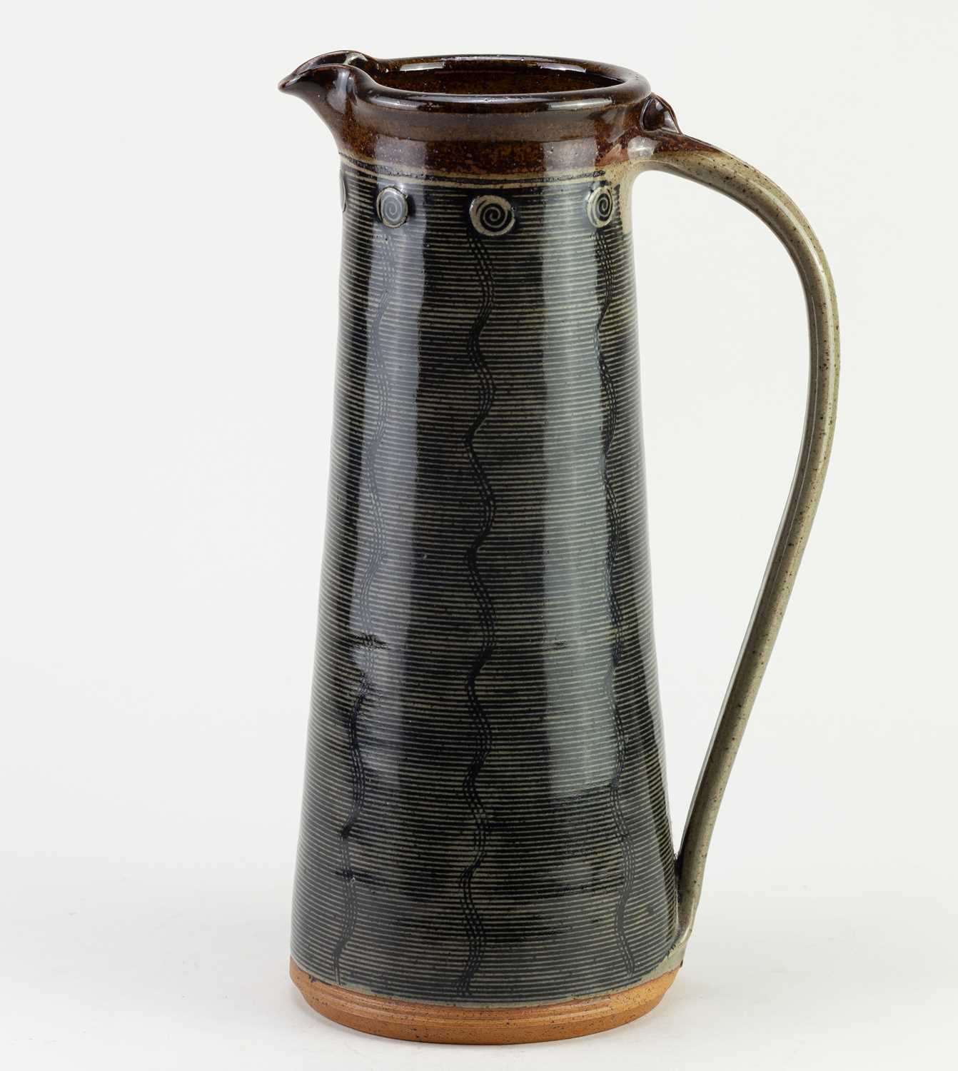 Lot 447 - JENNIE GILBERT; a tall stoneware Mishima jug,...