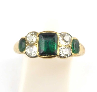 Lot 870 - A yellow metal emerald and diamond ring, the...