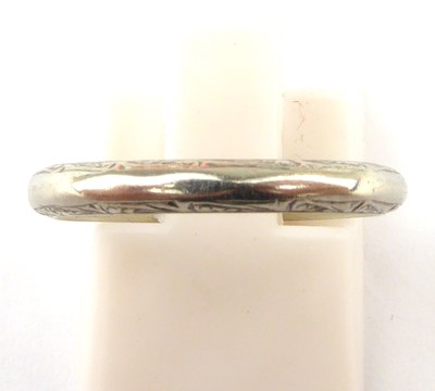 Lot 980 - An 18ct white gold thin wedding band, size L,...