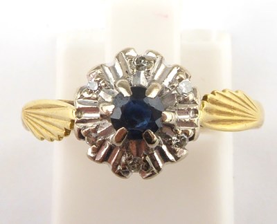 Lot 912 - An 18ct gold diamond and sapphire ring, the...