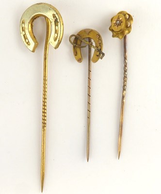 Lot 1208 - Three scarf pins comprising a small 9ct gold...