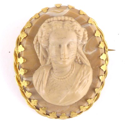 Lot 1073 - A 19th century lava carved cameo brooch in a...