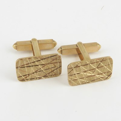 Lot 1199 - A pair of 9ct gold cufflinks with textured...