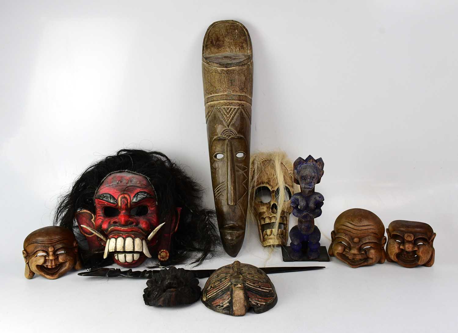 Lot 320 - Various African tribal masks to include a red...