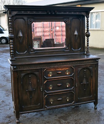 Lot 1611 - An early 20th century oak mirror back...