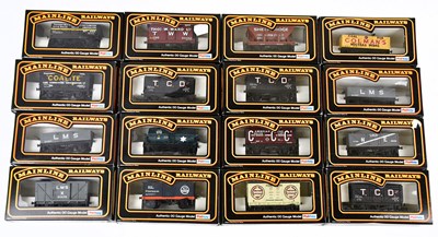 Lot 163 - MAINLINE; sixteen boxed OO gauge wagons to...