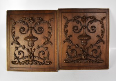 Lot 130 - A pair of French walnut panels carved with...