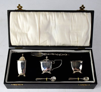 Lot 779 - A cased white metal three-piece cruet set,...