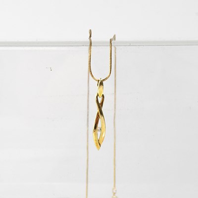 Lot 1113 - A 9ct yellow gold chain suspending a 9ct...
