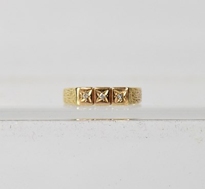 Lot 1014 - A 9ct yellow gold ring set with three diamond...