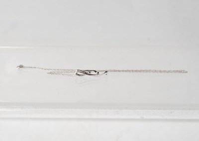 Lot 1118 - A 9ct white gold pendant suspended on a very...